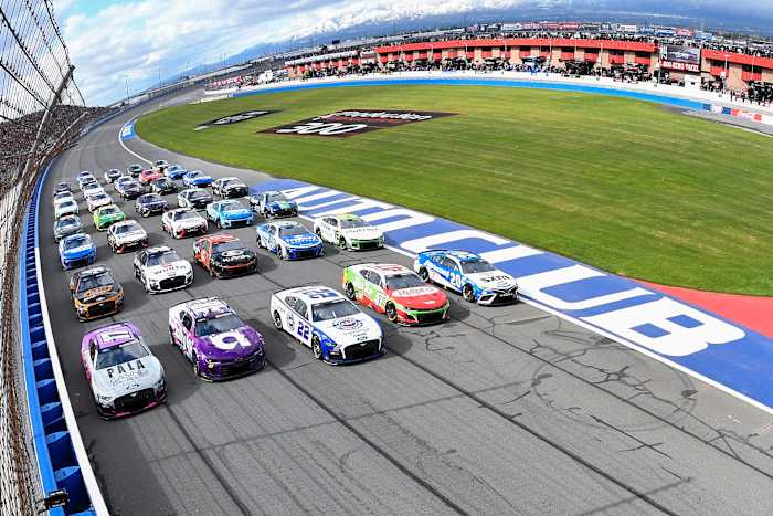 Christopher Bell, 2023 Daytona 500 winner Ricky Stenhouse Jr., Joey Logano, Alex Bowman and Chris Buescher lead the field in a five-wide salute to the fans prior to the Pala Casino 400 at Auto Club Speedway. (Photo by Logan Riely/Getty Images)